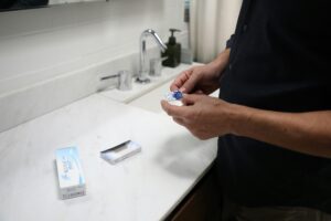 man putting in acuve contact lenses